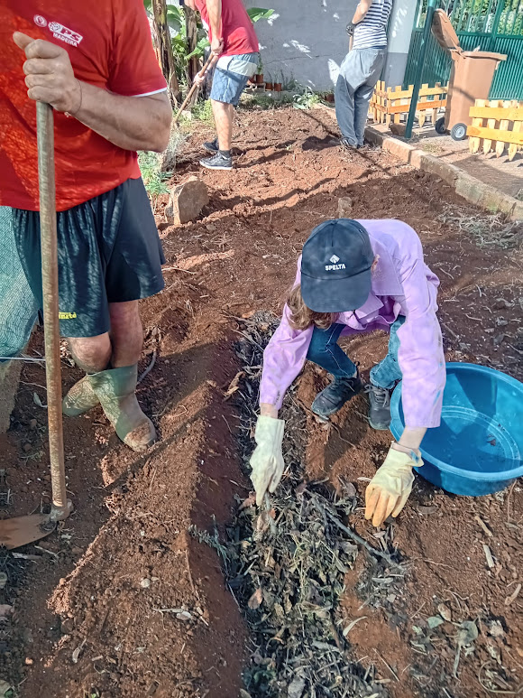 Colocação do composto na terra por parte dos utentes do CACI Santa Cruz, com objetivo de fertilizar a terra.
